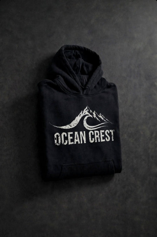 Folded black hoodie with white OCEAN CREST graphic.