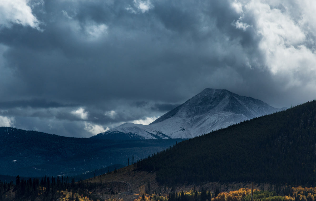 Mountain landscape under a dark stormy sky.